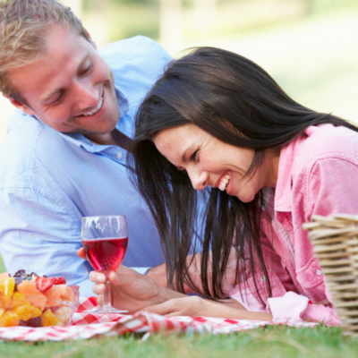 Couple enjoying a picnic Casey Green Weddings Date Night blog post
